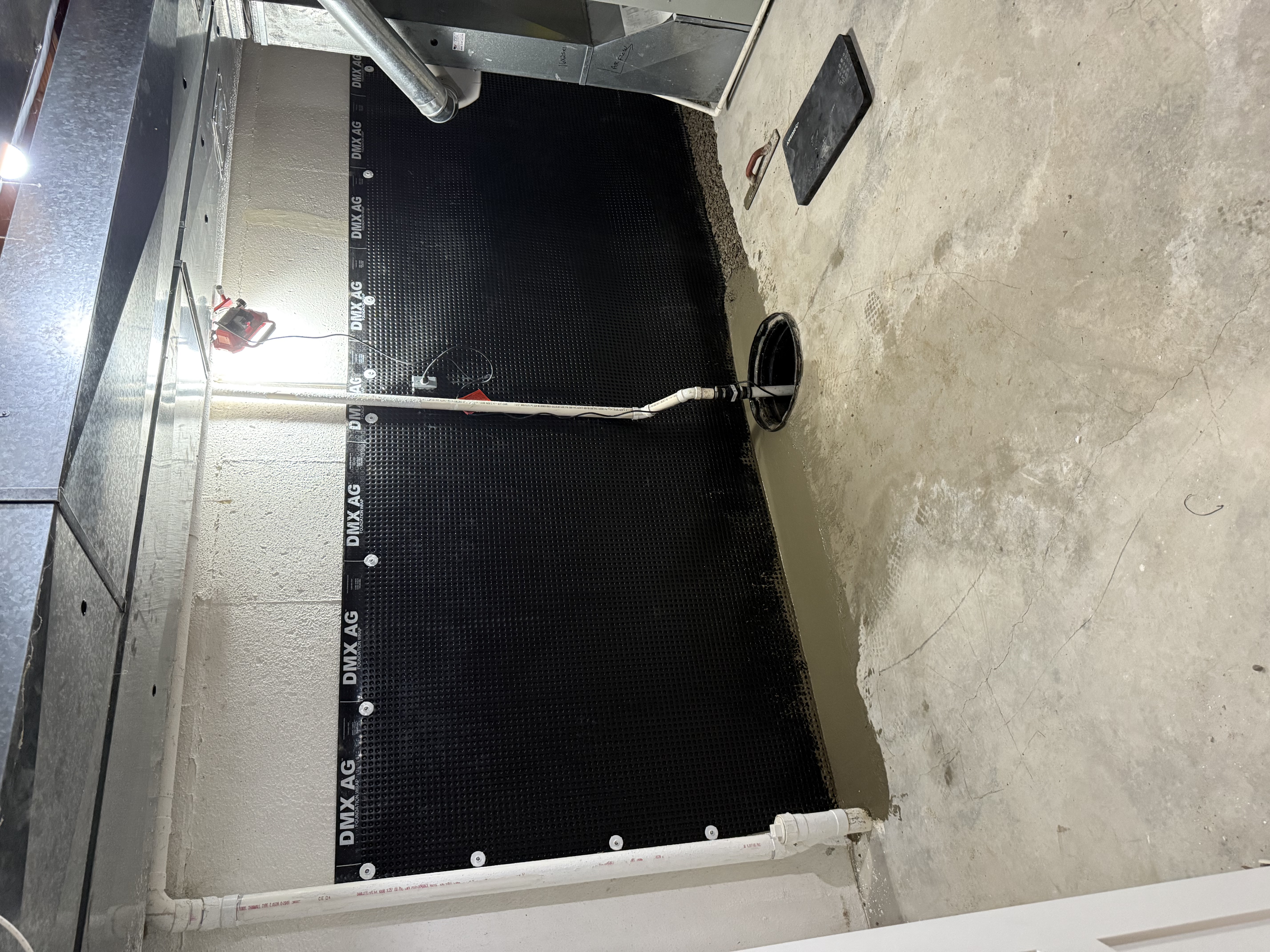 Basement waterproofing work in progress